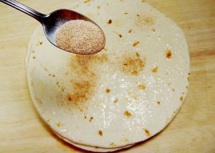 Sprinkling Cinnamon Sugar on Flour Tortillas