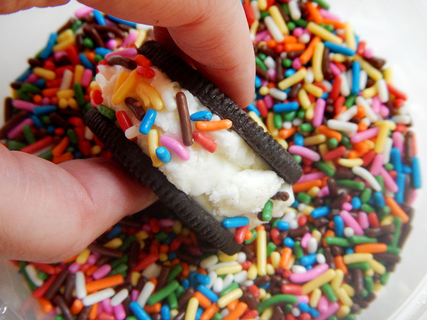 Rolling an Oreo ice cream sandwich in sprinkles