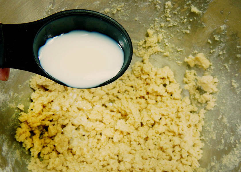 Adding Milk to Cinnamon Shortbread Dough