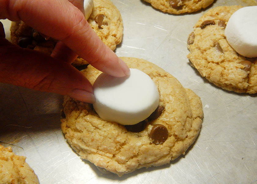 Placing a marshmallow on a s'more cookie